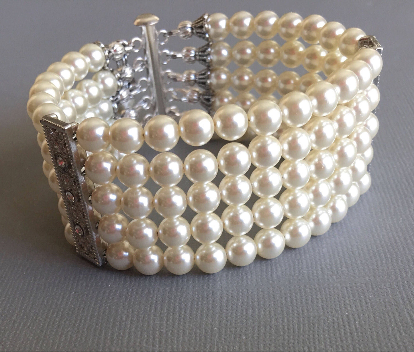 Pearl Bridal Bracelet with Silver bars and rhinestone is a 5 multi strands cuff of crystal glass Pearls in Cream ivory or choice of color